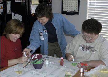 Arrion, Annette, and Nancy decorating cookies