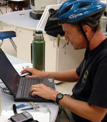 Steve in bike helmet at computer